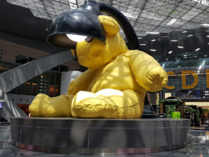 Lamp Bear sculpture and luxurious terminal at Hamad International Airport.